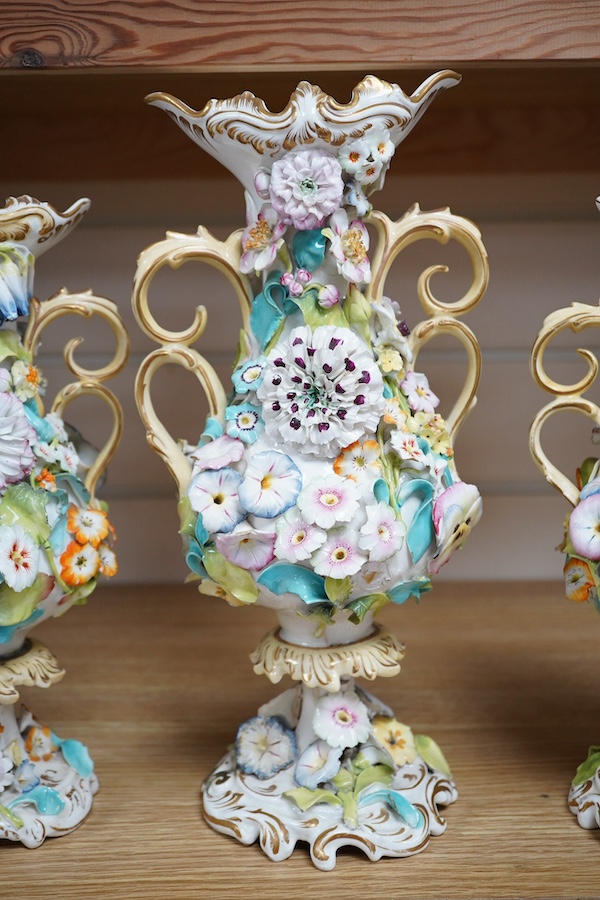 A Coalport garniture vase set with applied flowers, tallest 31cm. Condition - restored